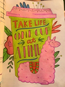 A reviewer's colored-in coloring book page with a llama in front of a to-go coffee cup labeled