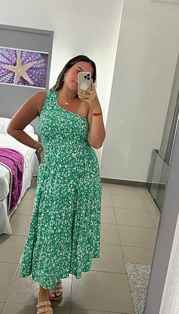 reviewer in mirror wearing green floral dress and white sandals