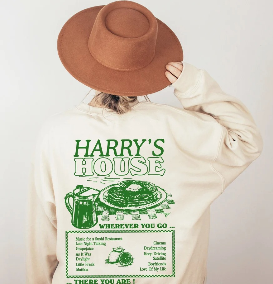 model wearing the beige sweatshirt and showing the back with a 'Harry's House