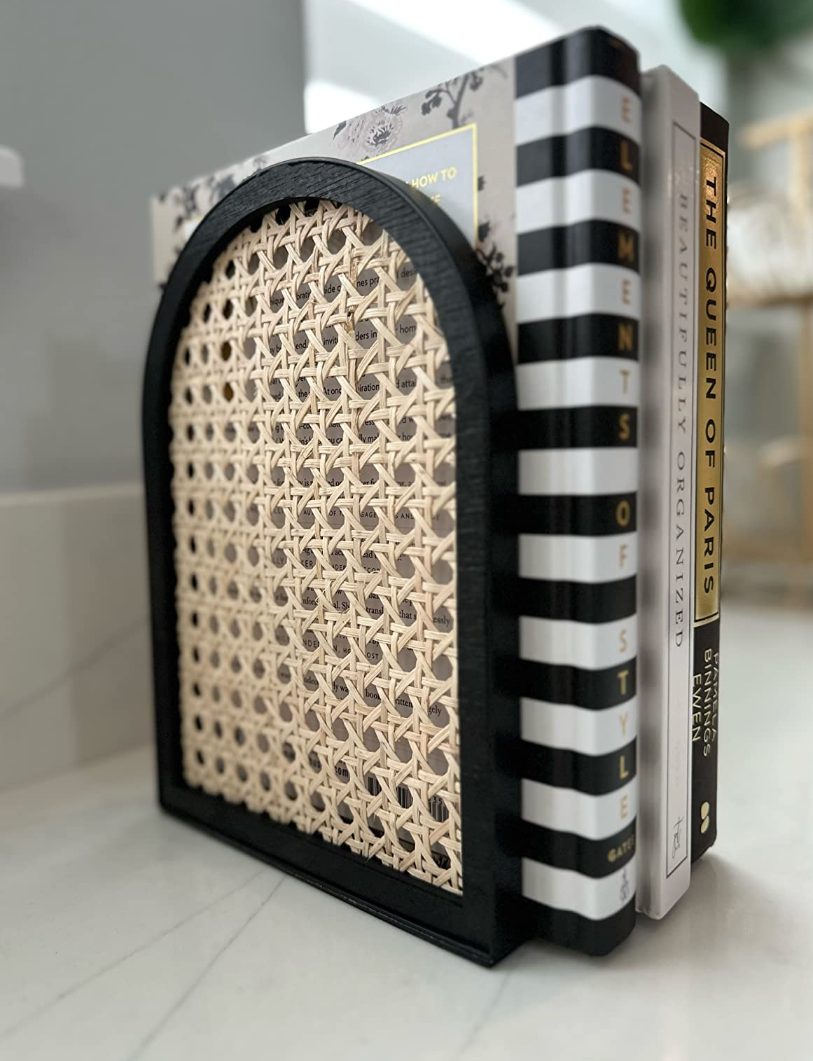 dusky and rattan bookend holding up a reviewer's books
