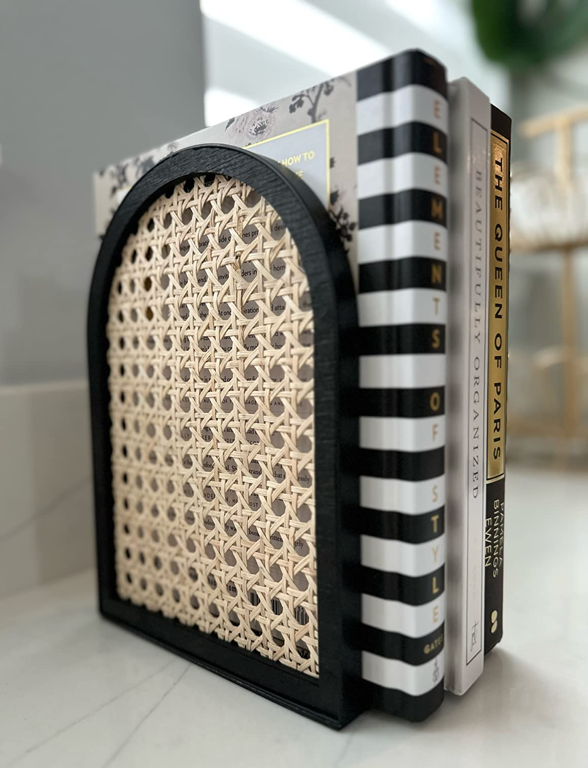 dusky and rattan bookend holding up a reviewer's books