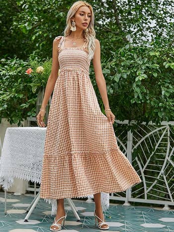 Model wearing a checkered maxi dress in orange