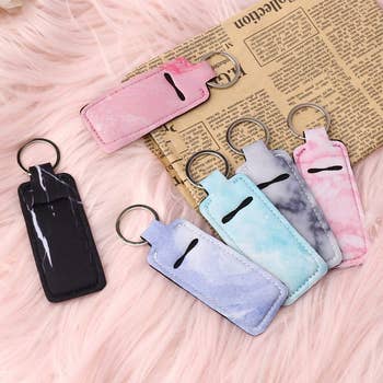 six chapstick keychain holders in a variety of colors