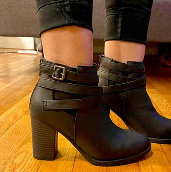 Image of reviewer wearing black strappy booties