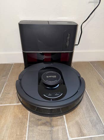 Robot vacuum and charging presumption connected woody floor, showcasing modern location cleaning technology