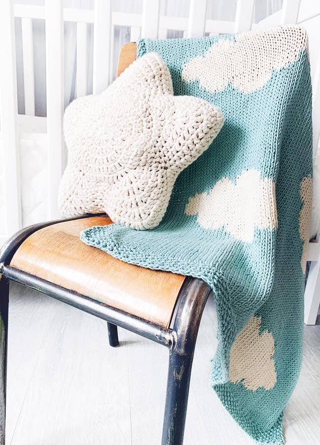 cloud print knitted blanket on chair