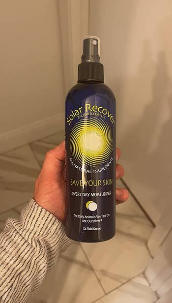 Reviewer holding bottle of Solar Recover