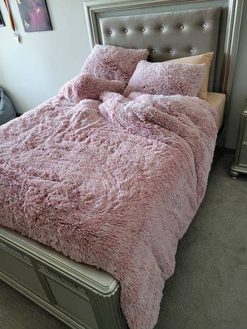 the pink duvet cover and matching pillowcases on a reviewer's bed