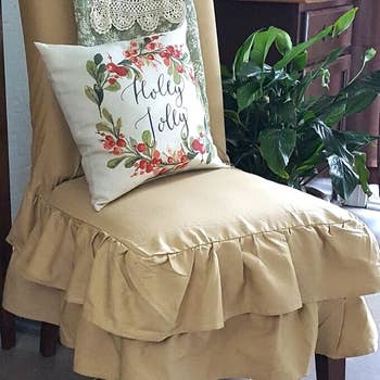 reviewer's chair with khaki ruffled slipcover and pillow