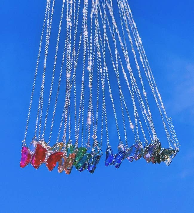 the glass butterfly pendants in different colors on silver chains