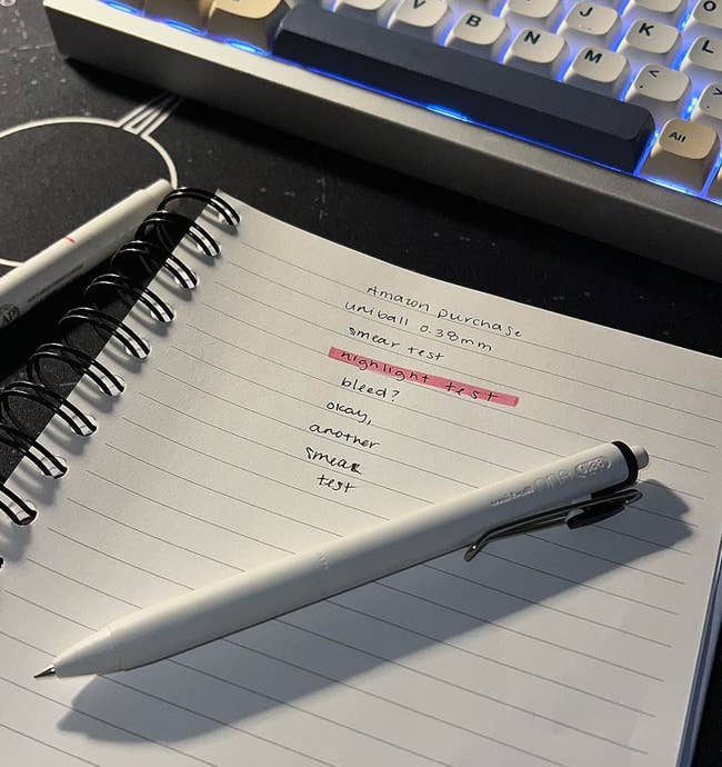Open notebook with handwritten notes comparing pen ink performance, featuring presumption similar