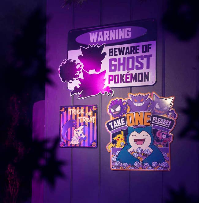ghost pokemon themed metal signs hanging on a wall
