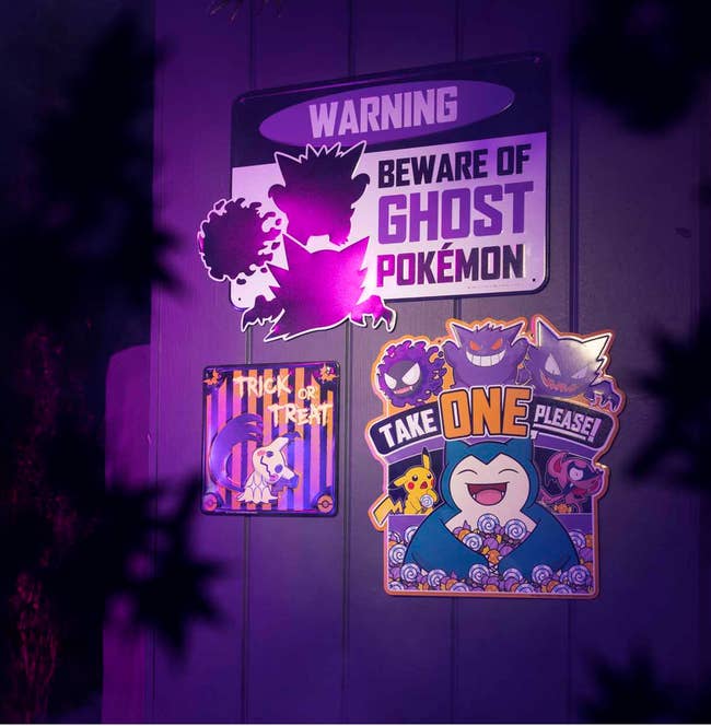 ghost pokemon themed metal signs hanging on a wall