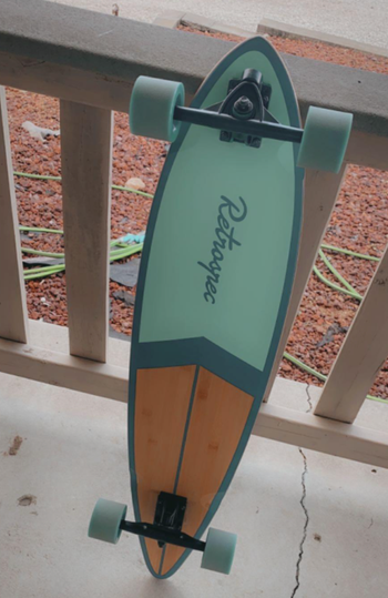 Reviewer photo of the longboard in a turquoise blue color