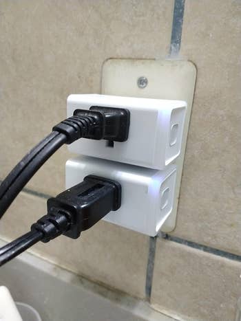 reviewer's outlet with two small white rectangular smartplugs 