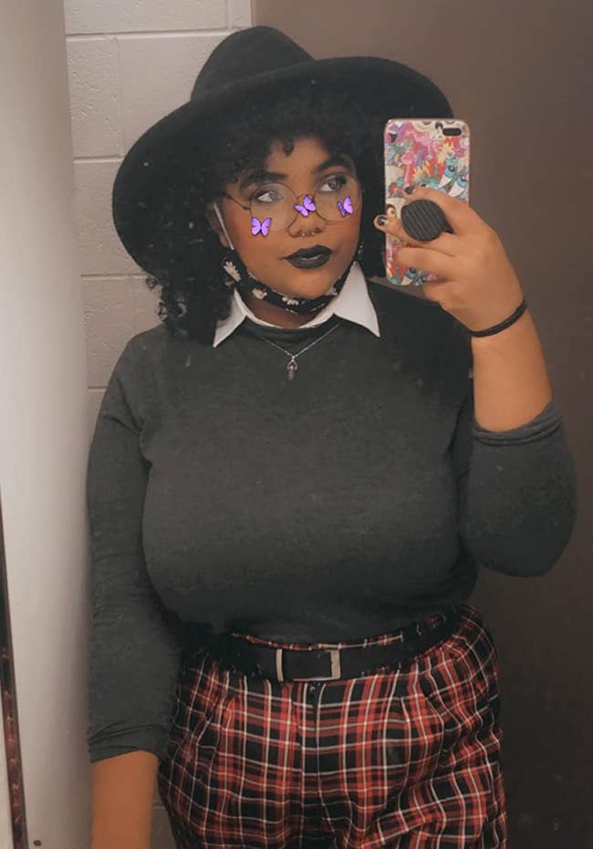 A reviewer wearing the dickey collar successful achromatic nether a crewneck grey sweater and reddish plaid pants.