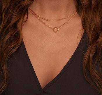 model wearing the gold necklace set