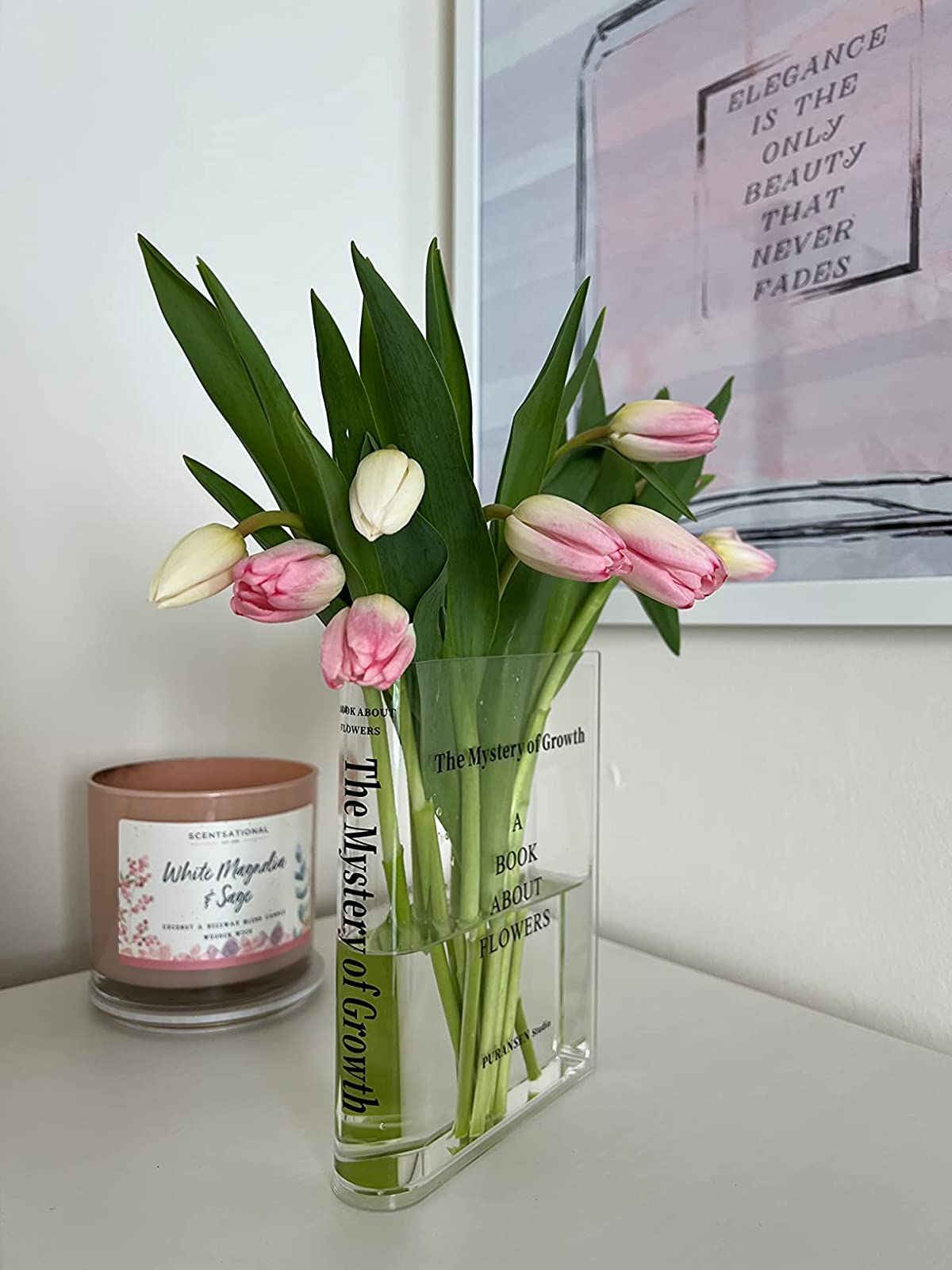 the transparent vase filled with tulips