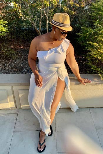 reviewer wearing the white bathing suit with a white skirt and hat
