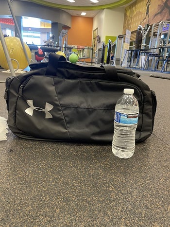 reviewer photo of black Under Armour gym bag at the gym