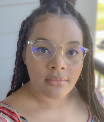 reviewer wearing the clear frame blue light blocking glasses