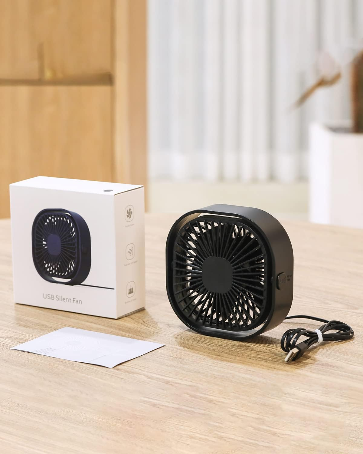 USB silent fan on a table with its box, showing product design for a shopping article