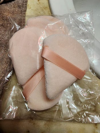 two pink triangle powder puffs