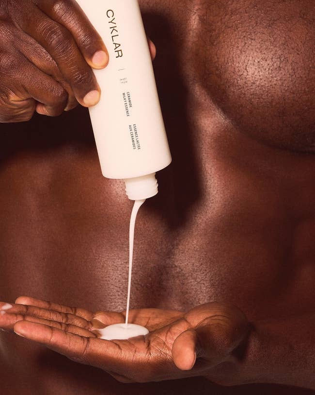 Person pouring lotion from a Cyklar vessel onto their hand, emphasizing skincare routine
