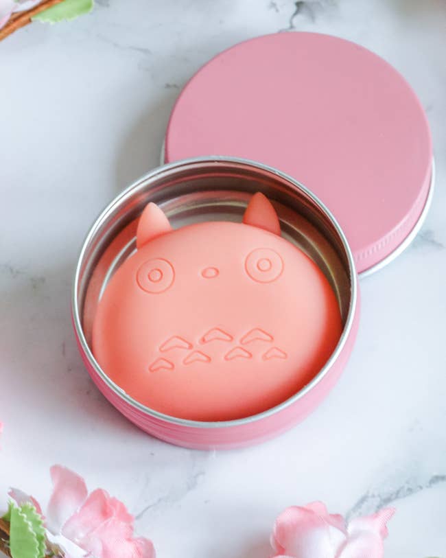 Round soap successful a tin, shaped similar totoro