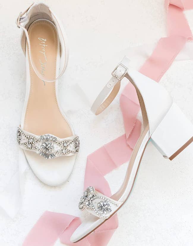 the white ankle strap sandals with crystal embellishment on toe strap