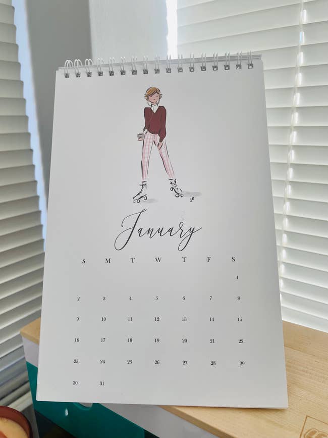 white desk calendar with an illustration of Princess Diana on it