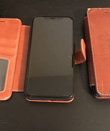 Reviewer image of product in brown with phone inside and three card slots