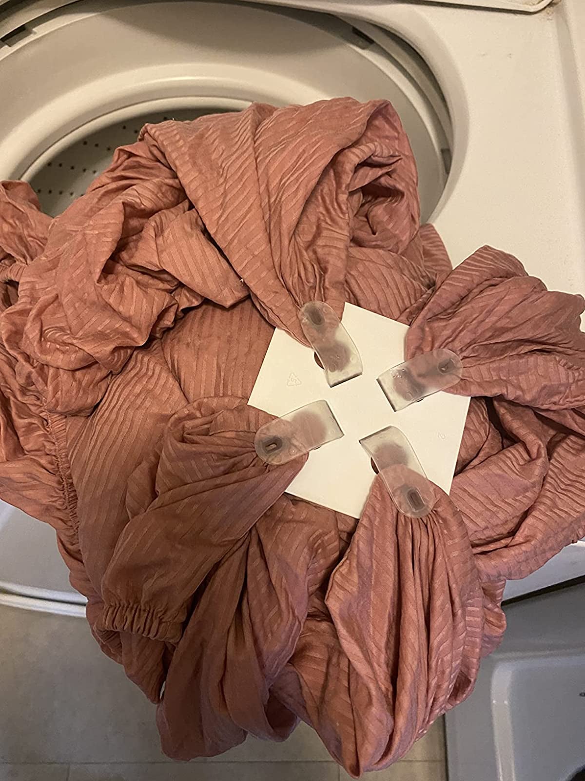 problem solving products reviewer image of a burgundy sheet with corners inside the wad-free sheet detangler
