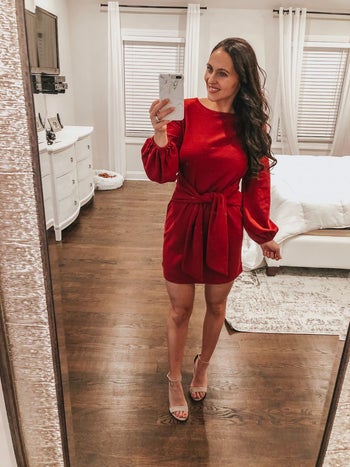 reviewer mirror selfie wearing the dress in red