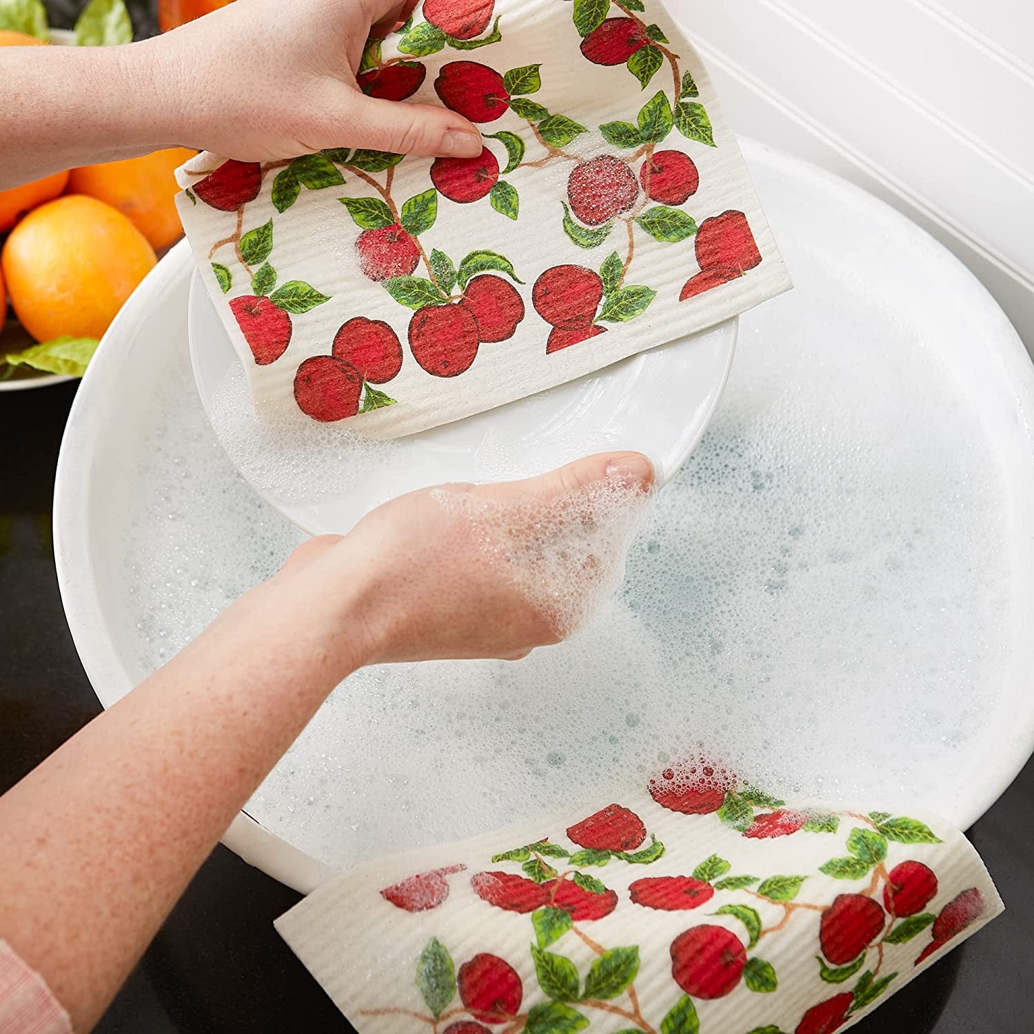 A model washing dishes with white cloths with painted cherry pattern