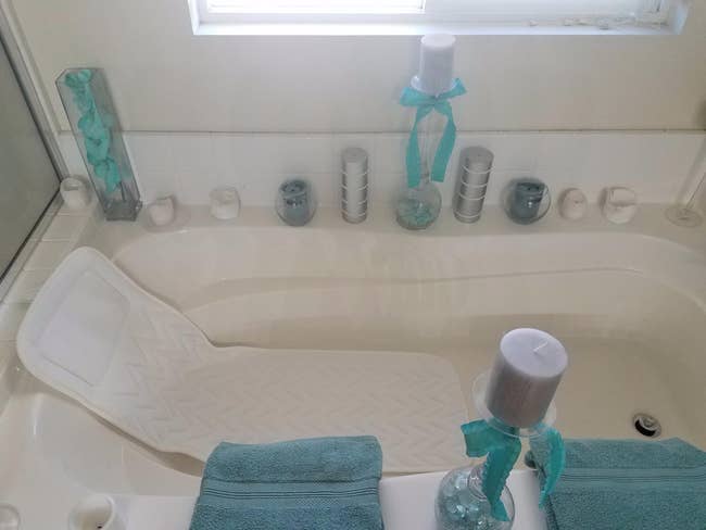 a reviewer photo of the pillow in a bathtub 