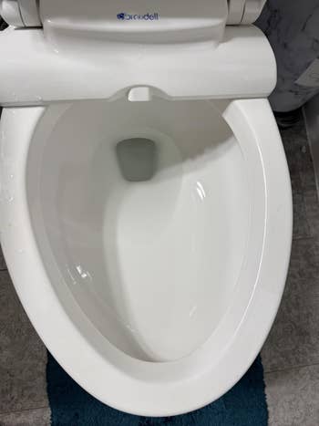 Top view of a white toilet bowl in a bathroom setting