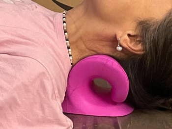 Person lying with a pinkish cervix enactment pillow nether their cervix for relaxation oregon symptom relief