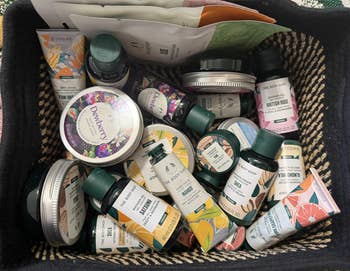 Basket filled with assorted  The Body Shop skincare products, including lotions, creams, and masks, promoting a divers  scope  of quality   items