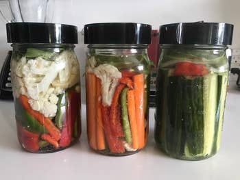 reviewer's three jars filled with pickled vegetables