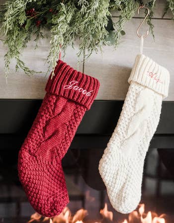 the red and cream stockings hanging over a fireplace