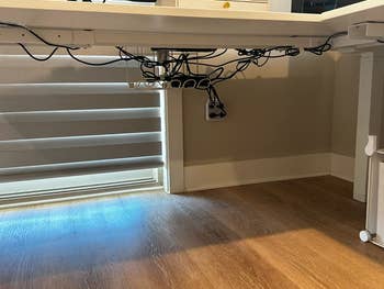 Under a desk, assorted cables are organized utilizing a cablegram absorption tray, adjacent to a acceptable of horizontal blinds