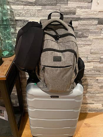 Reviewer photo of laptop backpack on top of suitcase