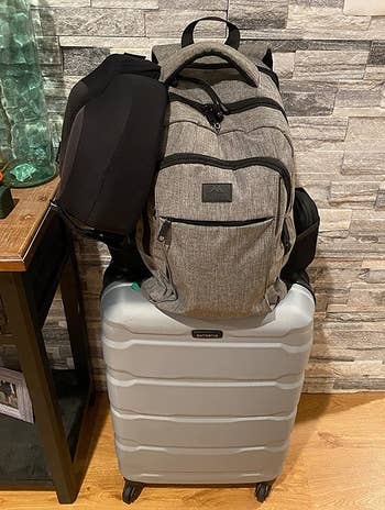Reviewer photo of laptop backpack on top of suitcase