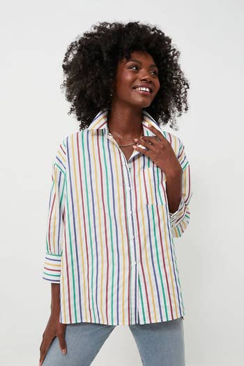 model in rainbow striped white button up long sleeve top 