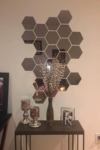a reviewer places the hexagon decals above a side table