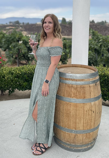 Reviewer wearing the green dress at a winery