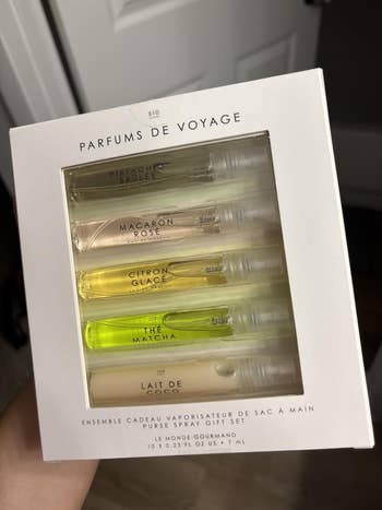 Set of 5 travel-sized perfumes named Pistachio Brûlée, Macaron Rosé, Citron Glacé, Thé Matcha, and Lait de Coco successful a achromatic package