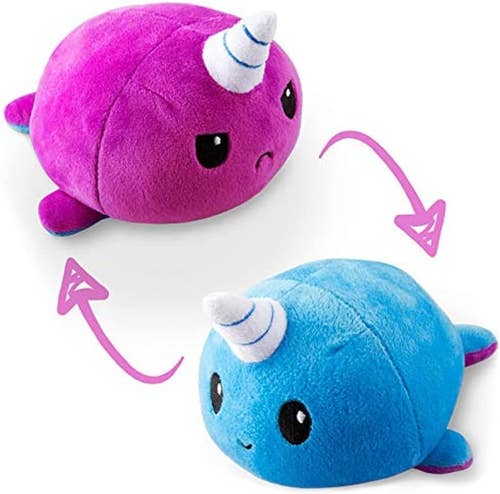 purple frowning narwhal plush and then plush flipped to blue smiling version