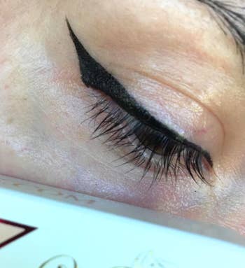  reviewer photo of a stamped-on black cat-eye wing on their face